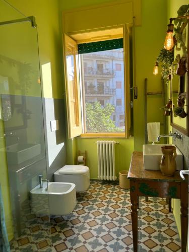 a bathroom with a sink and a toilet and a window at Don Ciccio Capashome in Ceglie Messapica