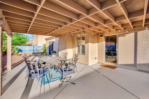a patio with a table and chairs on it at Sports Themed--Automated King Bed--Family Friendly--5 miles to Strip in Henderson