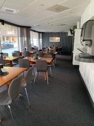 a dining room with wooden tables and chairs at Bodø Hotel in Bodø