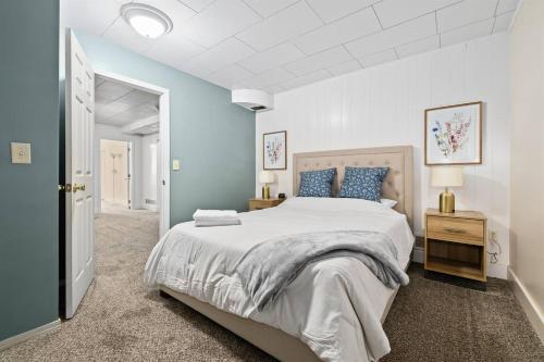 a bedroom with a large bed with blue walls at 1950s Charmer in Boise