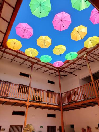 a bunch of umbrellas hanging from the ceiling at HOTEL BOUTIQUE SIMACOTA in Simacota