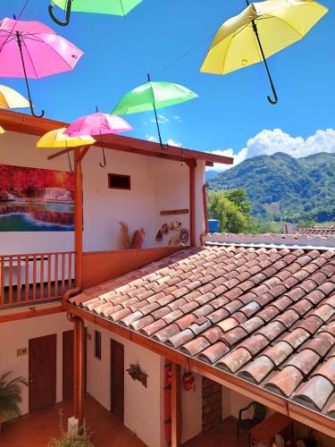 a house with umbrellas on top of a roof at HOTEL BOUTIQUE SIMACOTA in Simacota