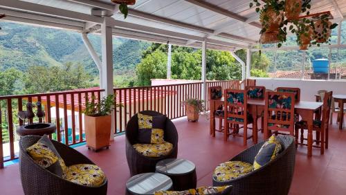 a balcony with chairs and a table with a view at HOTEL BOUTIQUE SIMACOTA in Simacota