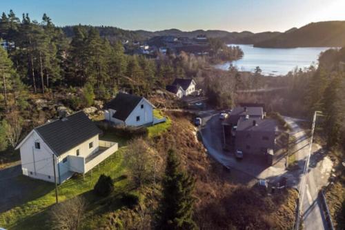 an aerial view of a house on a hill next to a lake at Hytte Sørlandet med spa in Froland Verk