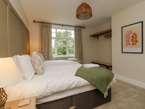 a bedroom with a white bed with a window at The Wheatley in Ilkley