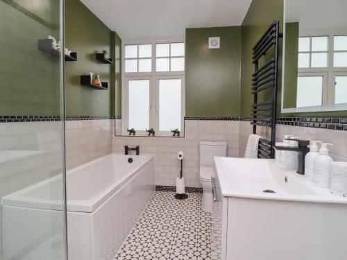 a bathroom with a tub and a sink at The Wheatley in Ilkley