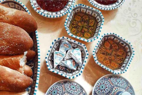 a table with plates and donuts on it at Villa piscine Agadir in Agadir