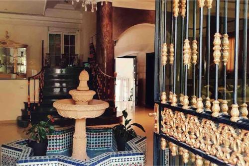 a room with a fountain in the middle of a room at Villa piscine Agadir in Agadir