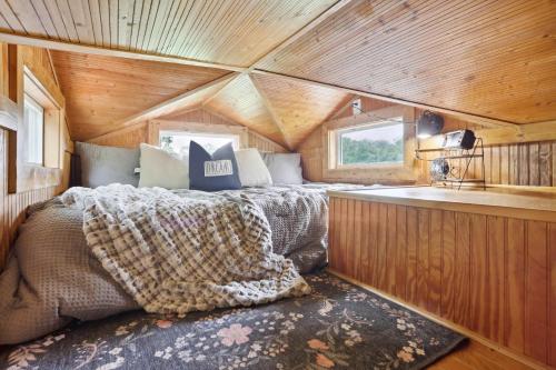 a bedroom in a tree house with a bed in it at Pendergrass Tiny Home Cabin on Pond with Fire Pit! in Braselton
