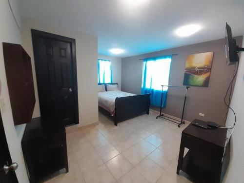 a room with a bedroom with a bed and a window at Departamentos velasco in Tijuana
