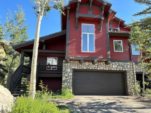a red house with a garage in front of it at Snowcreek V #757 condo in Mammoth Lakes
