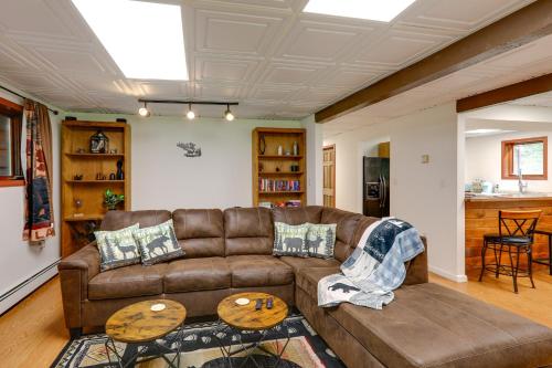 a living room with a brown couch and two tables at Ideally Located Fairbanks Vacation Rental! in Fairbanks
