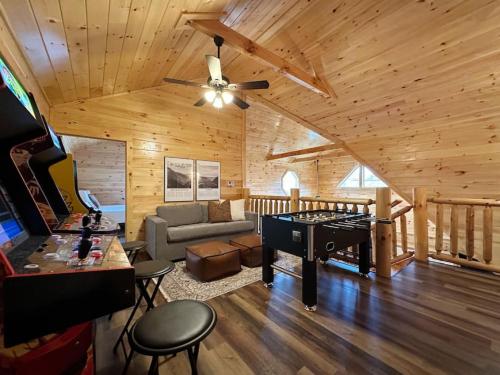 a living room with a ceiling fan and a piano at Wildwood Retreat Indoor Pool Hot Tub Game Area in Pigeon Forge
