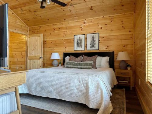a bedroom with a bed in a log cabin at Wildwood Retreat Indoor Pool Hot Tub Game Area in Pigeon Forge