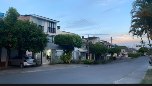 a street with houses and a car parked on the street at BORA - Apto 101Tu espacio fuera de casa in Ibagué