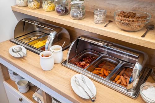 a kitchen with two trays of food on a counter at Hotel Zlatá Hvězda in Litomyšl
