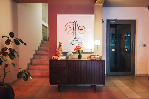 a hallway with a dresser and a staircase with a door at Casa San Fernando by Barrio México in Guadalajara