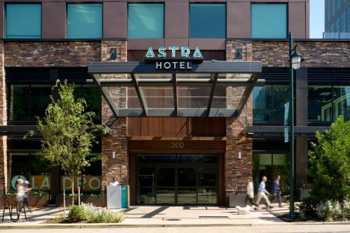 a facade of an asia hotel with people walking outside at Astra Hotel, Seattle, a Tribute Portfolio Hotel by Marriott in Seattle