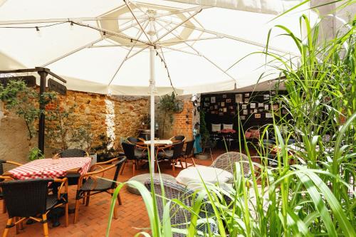a patio with tables and chairs and an umbrella at Rynek 10 Apartments in Lublin