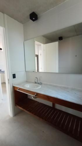 a bathroom with a sink and a large mirror at Nereida in Mar Azul