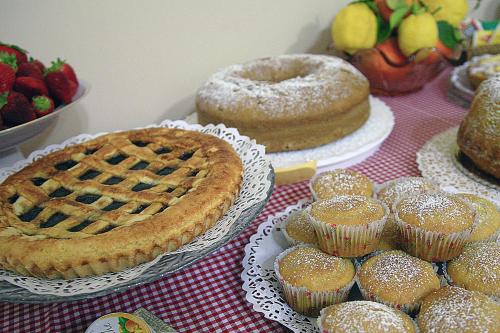 a table topped with pies and muffins and fruit at B&B La Filanda in Scilla
