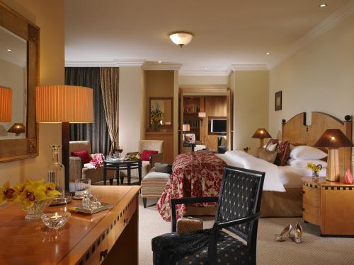 a hotel room with a bed and a living room at Mount Wolseley Hotel Spa & Golf Resort in Tullow