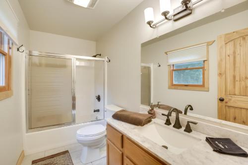 a bathroom with a sink and a toilet and a shower at Creekside Ten Sleep Vacation Rental and Deck and Grill in Ten Sleep