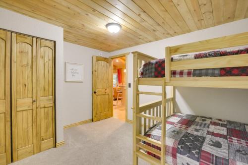 a bedroom with two bunk beds and a hallway at Creekside Ten Sleep Vacation Rental and Deck and Grill in Ten Sleep