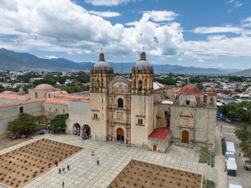 an old church with a view of a city at Viajero Oaxaca Hostel in Oaxaca City