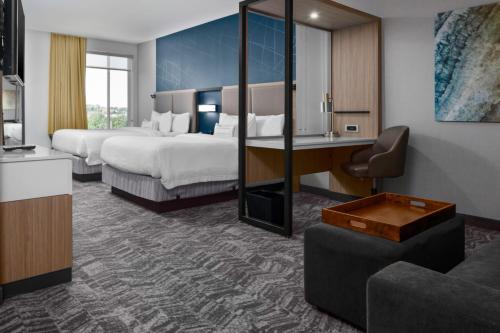 a hotel room with two beds and a desk at SpringHill Suites Winchester in Winchester