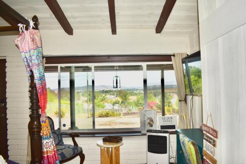 a room with a window with a view of the ocean at George Gardens in Ramona