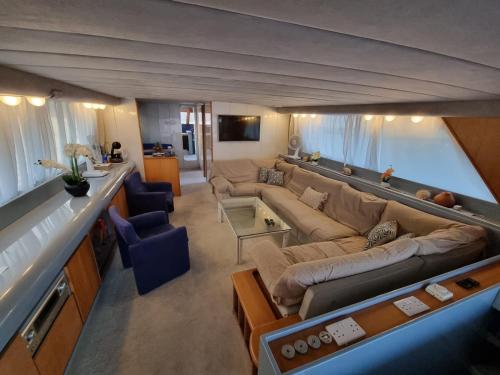 a large living room with a large couch and chairs at Riti Yacht in Kalkara