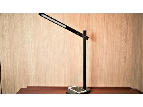 a black lamp sitting on top of a wooden wall at Y's Inn Naha Oroku Ekimae - Vacation STAY 25852v in Naha