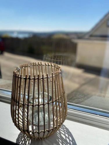 a wire basket sitting on top of a window at Salcombe View in Kingsbridge