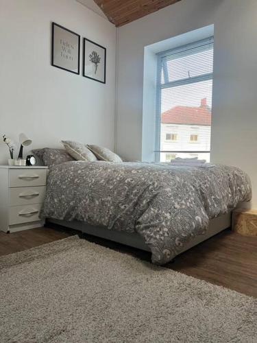 a bedroom with a bed with a dresser and a window at 1 bedroom flat Bristol centre in Bristol