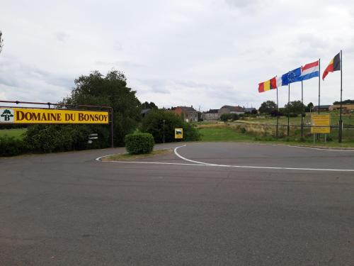 a sign on the side of a road with flags at Le Héron ( Gîte ) in Blaimont