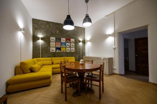 a living room with a yellow couch and a table at Casa Francesco in Pizzo