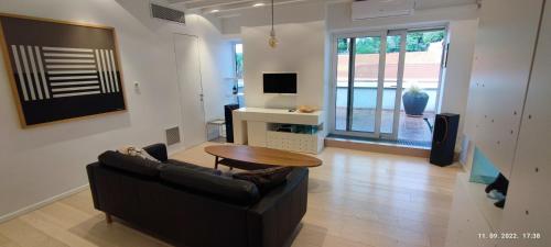 a living room with a couch and a table at Artissimo RoofTerace in Zagreb