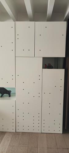 a room with white cabinets and a cat laying on the floor at Artissimo RoofTerace in Zagreb