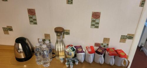 a counter top with a blender and a bunch of gift certificates at All Seasons Gatwick Guest House & Parking in Horley