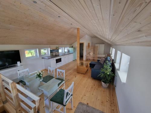 an overhead view of a living room and kitchen with a table and chairs at Scheune in Ostseenähe auch mit Pferd in Ducherow