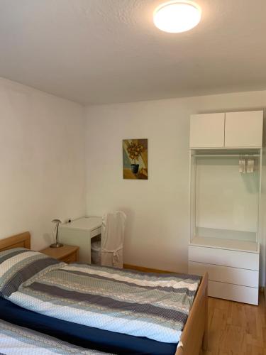 a bedroom with a bed and a desk at Apartment close to the center + free parking in Oldenburg