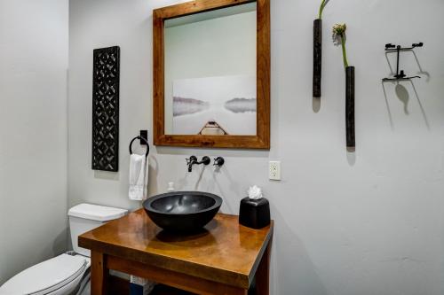 a bathroom with a bowl sink on a wooden table at The Porches in Steamboat Springs