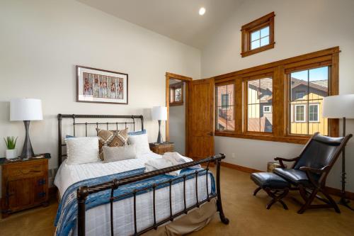 a bedroom with a bed and a chair at The Porches in Steamboat Springs