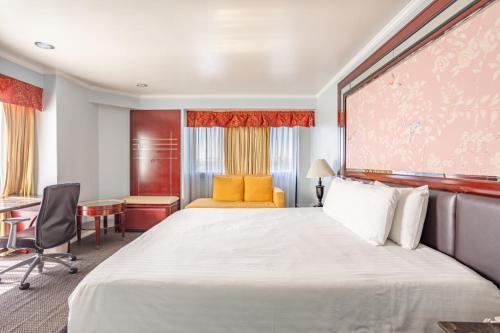 a hotel room with a large bed and a desk at Hotel Koxie in Los Angeles