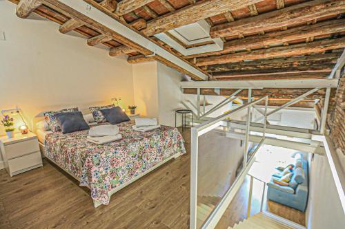 a bedroom with a bed with a wooden ceiling at Frida Salou ONLY FAMILIES in Salou