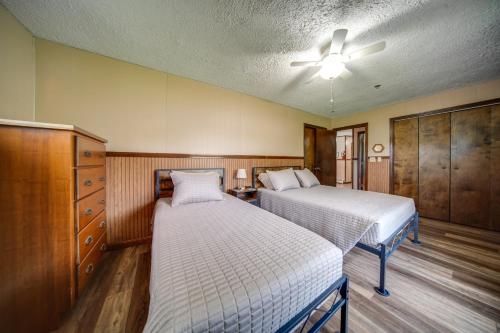 a bedroom with two beds and a ceiling fan at Lake Erie Getaway with Private Pool and Yard! in Conneaut