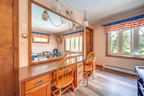 a dining room with a large mirror and chairs at Lake Erie Getaway with Private Pool and Yard! in Conneaut