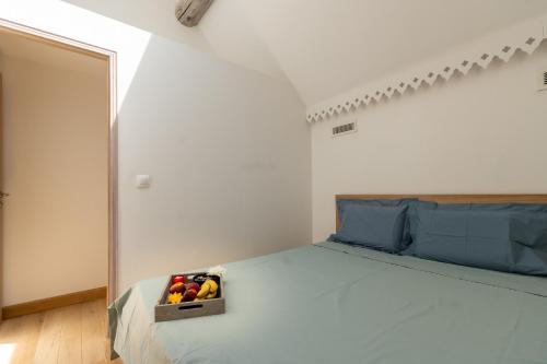 a bedroom with a bed with a box of fruit on it at Duplex T3 Climatisé in Marseille