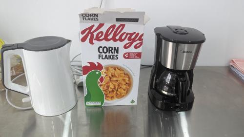 a box of turkey cereal next to a coffeemaker at Mufasa city Hostel and Apartments in Arusha